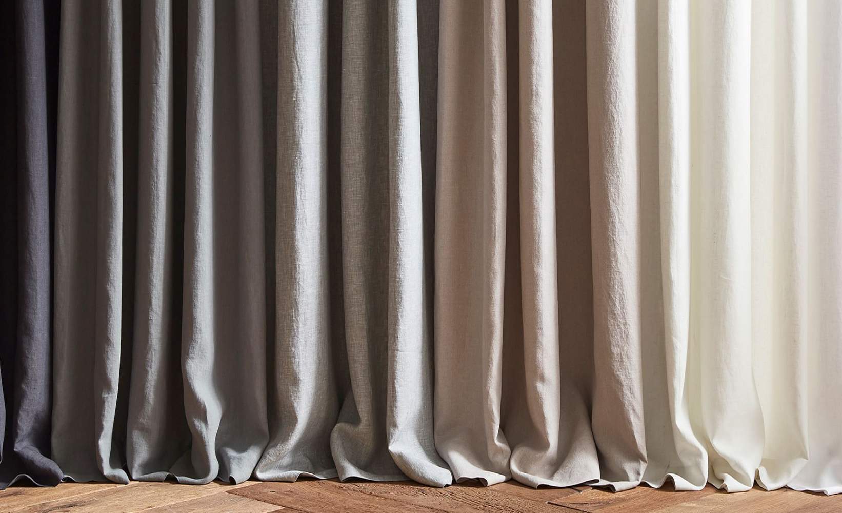 Collection of natural linen curtains in different tones, perfect for modern home decor Collection of natural linen curtains in different tones, perfect for modern home decor