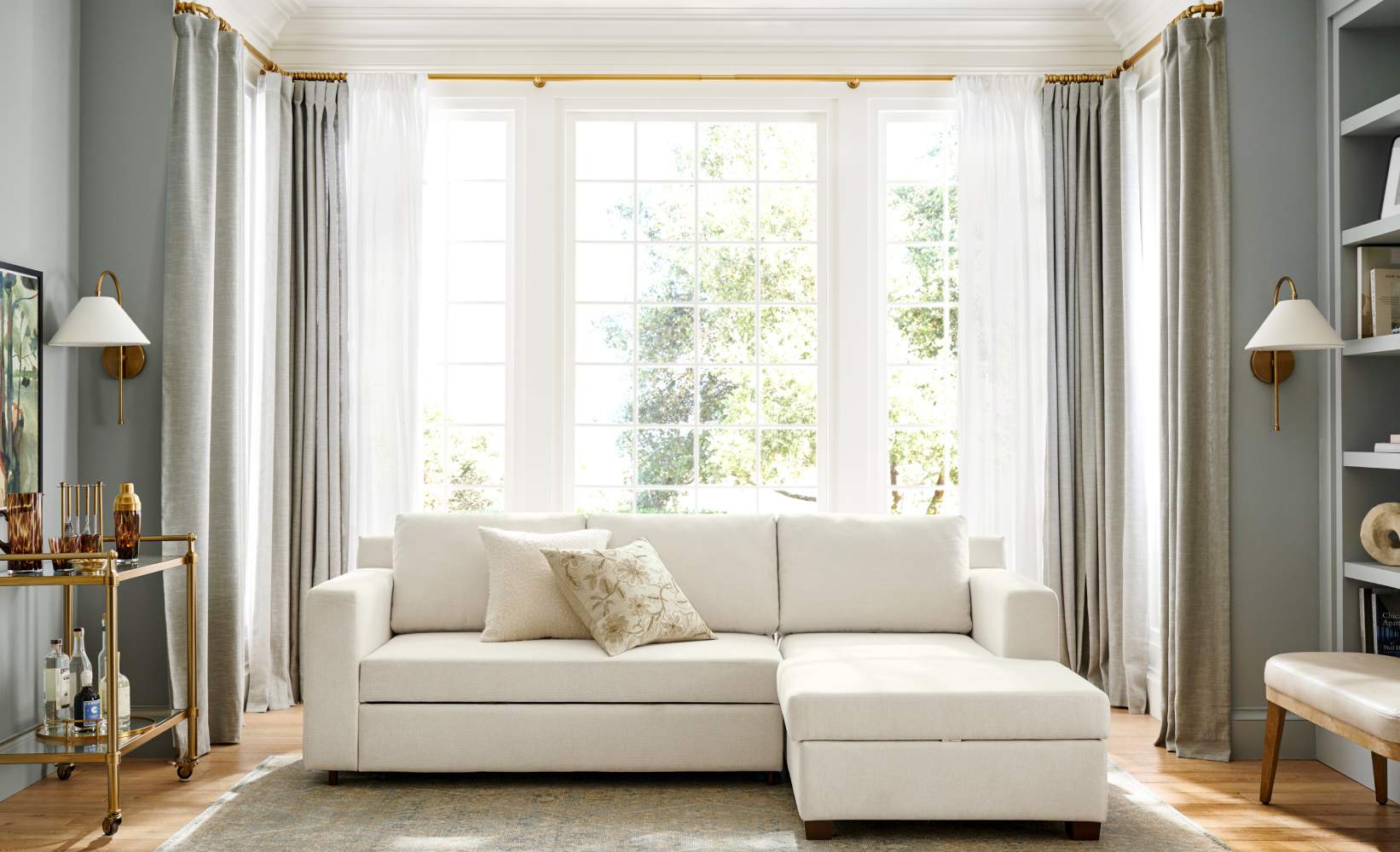 Grey linen curtains and sheer white drapes in a modern living room with a white sectional sofa Grey linen curtains and sheer white drapes in a modern living room with a white sectional sofa