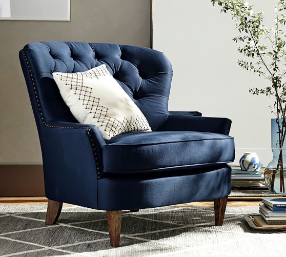 blue tufted armchair