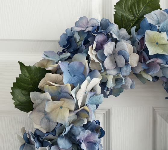 10% Plastic Vickerman 16 Artificial Blue Hydrangea Wreath 60% Polyester This Hydrangea Wreath Features a Blend of Light and Dark Blues with a hint of Green 20% Grapevine 