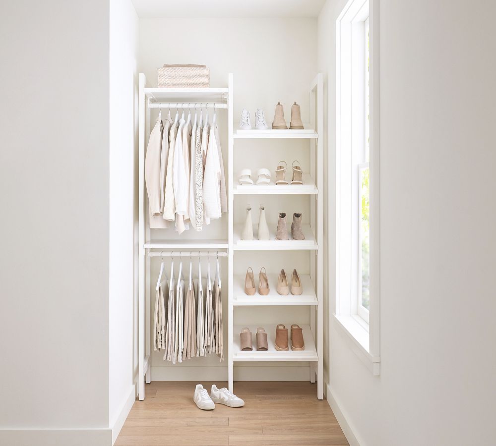 Large white walk-in closet features floor-to-ceiling custom shoe
