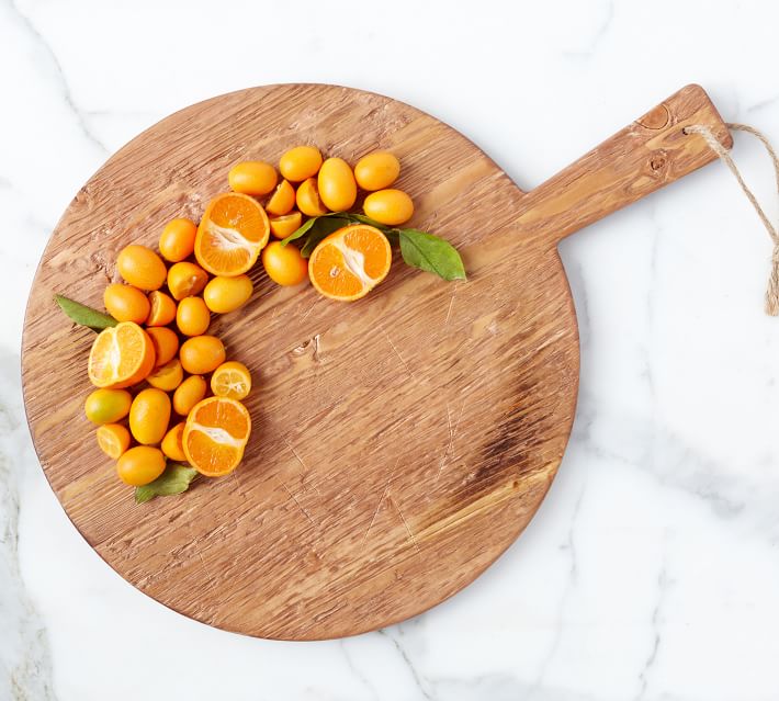 pizza cutting board at rustic wooden table Stock Photo by seregam