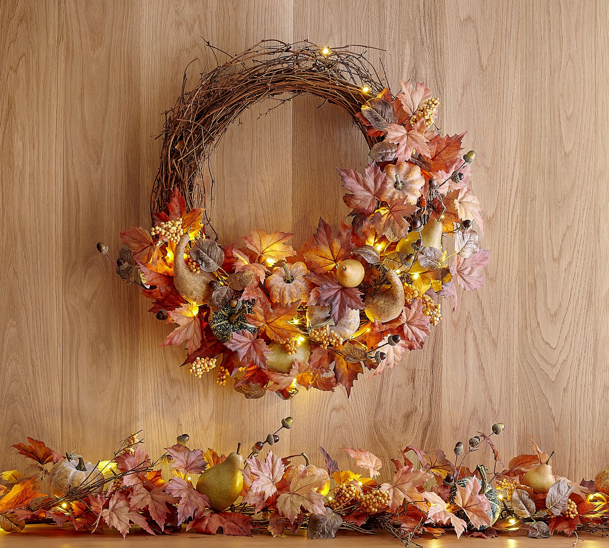 Light up wreath with faux leaves, pumpkins, and fruit from Pottery Barn