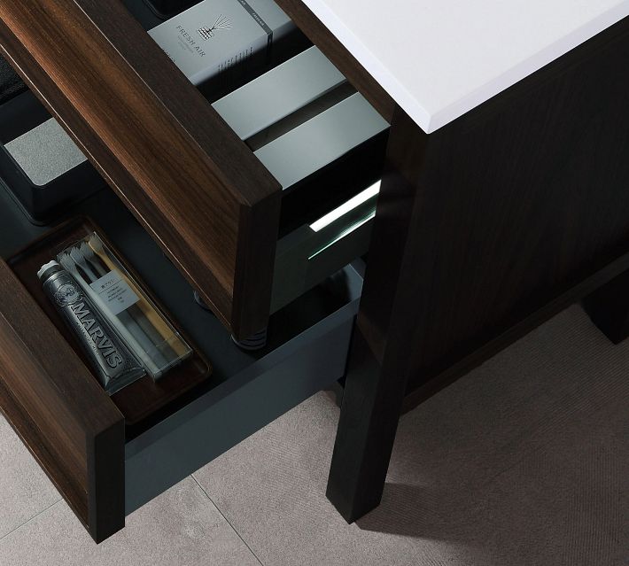 Open drawers showing organized storage with bottles and boxes.