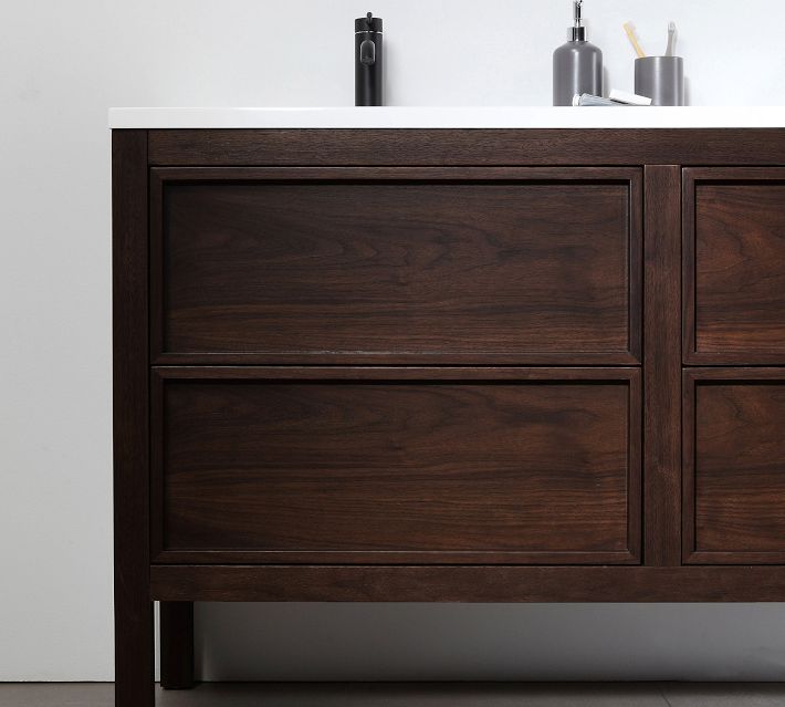 Front view of dark wood bathroom vanity with four large drawers and metal legs.