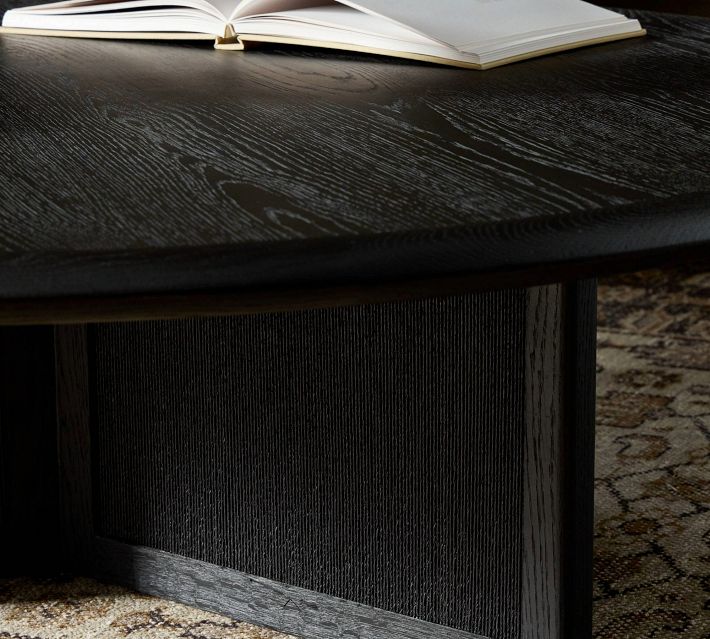 Close-up of round black wood coffee table top with wood grain texture