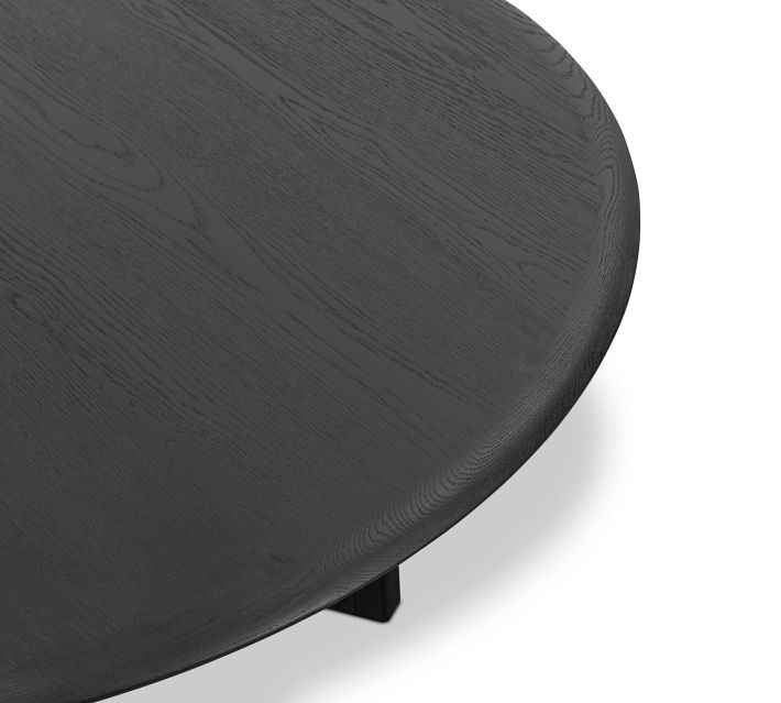 Another close-up of dark wood round table edge and leg