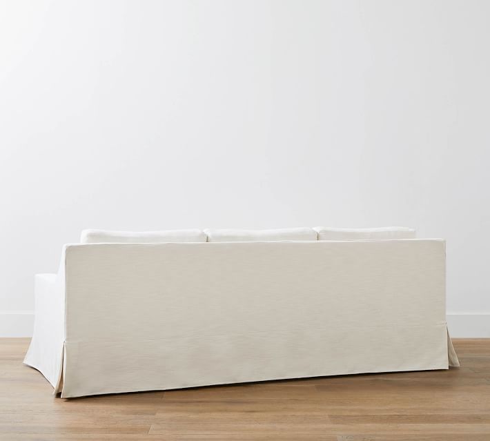 Rear view of beige sofa showing back and cushions.