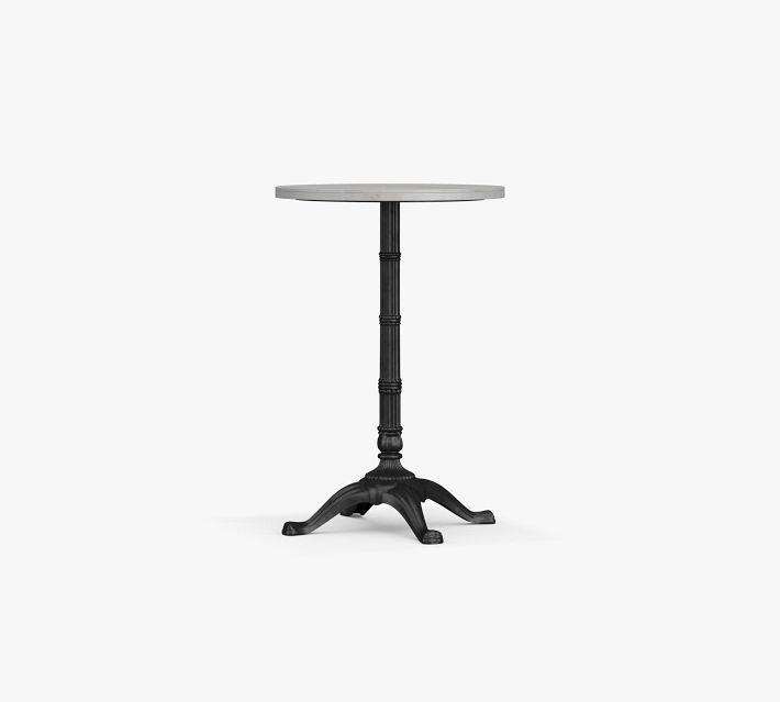Round pedestal table with black base and light wood top