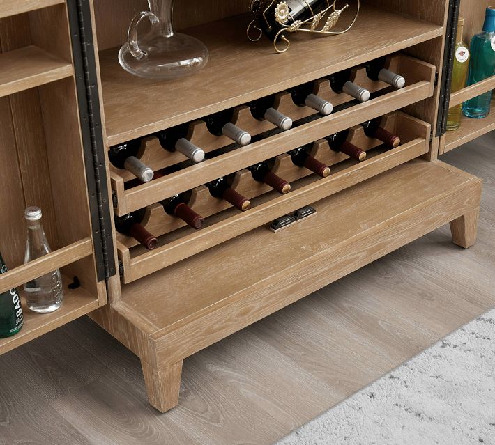 Lower section of cabinet with bottle rack and more storage.