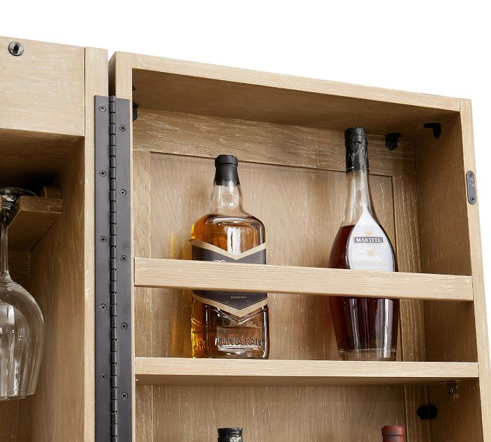 Two liquor bottles displayed inside a cabinet with shelves.