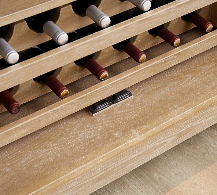 Close-up of wine rack with several bottles stored horizontally.