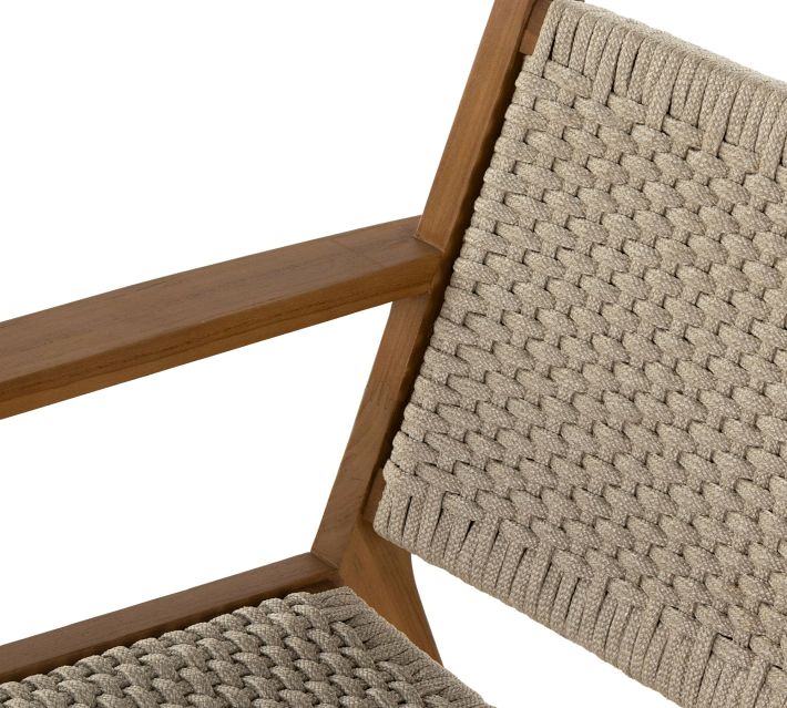 Close-up of the chair backrest showing woven beige rope material and wooden armrest