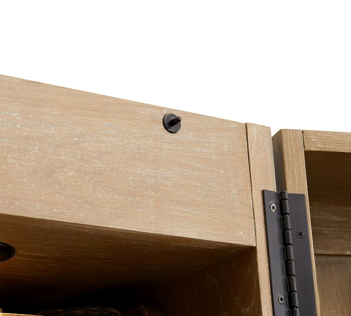 Close-up of door hinge and top edge of cabinet.