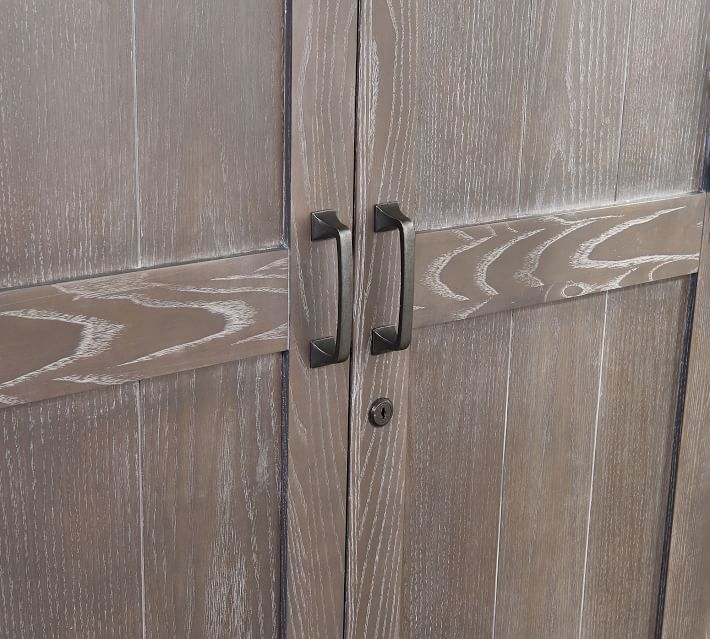Close-up of wooden cabinet doors with handles.