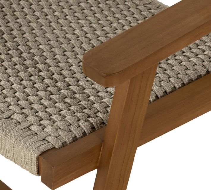 Side view of chair seat and armrest showing woven seat and wooden frame
