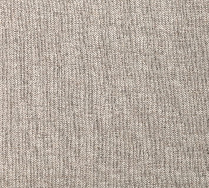 Close-up of beige fabric upholstery texture on chair seat