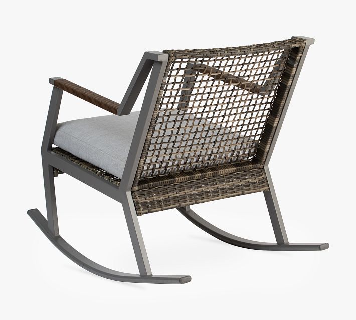 Two-toned wicker outdoor rocking chair back view with woven seat and cushion