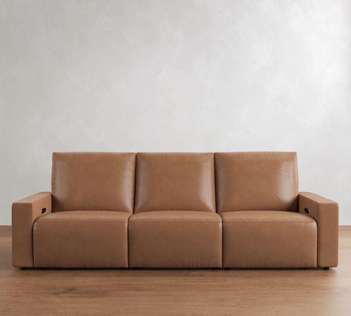 Three-seater tan leather sofa with clean lines and padded armrests, placed in a modern living room.