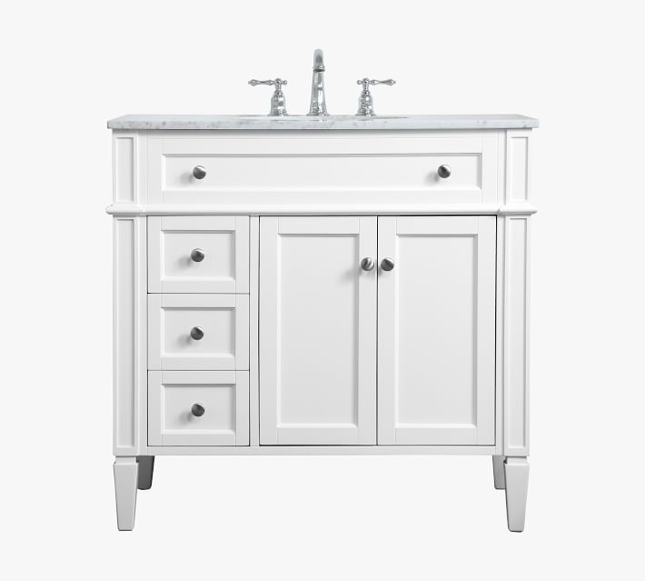 Full view of white bathroom vanity with marble top and chrome hardware