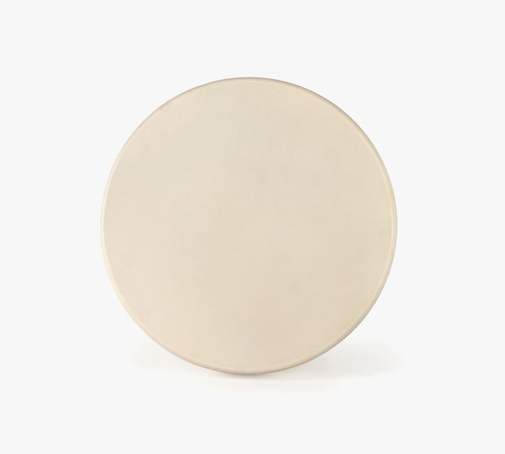 Top view of a plain round lid or plate in cream color.
