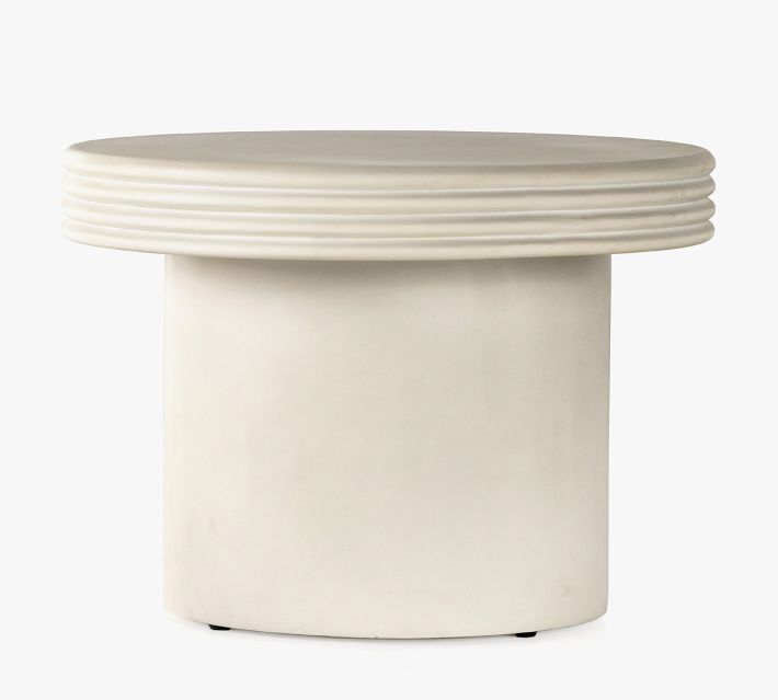Large round ribbed pedestal table with single cylindrical base.