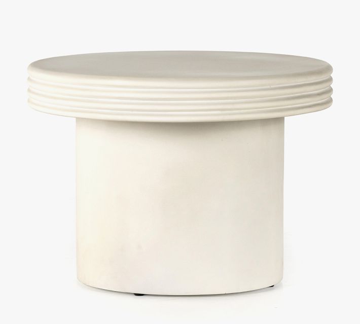 Circular pedestal table with ribbed edge and large base.