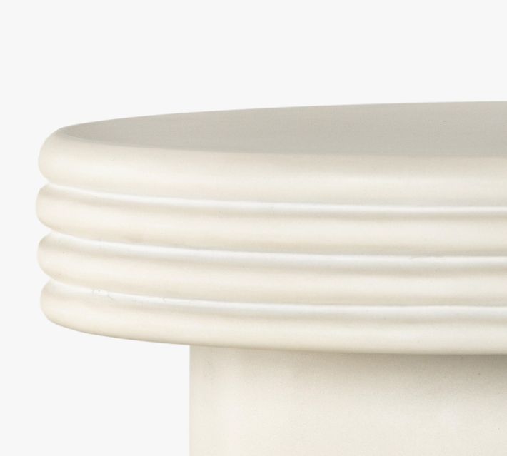 Close-up top edge of pedestal with multiple rings.