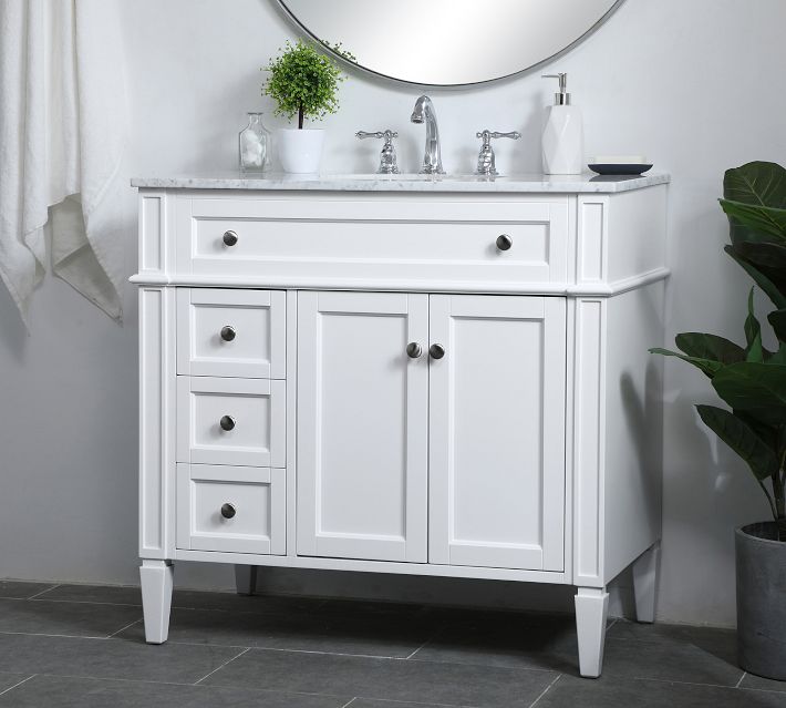 White bathroom vanity with marble countertop and multiple drawers, large center cabinet, and potted plant