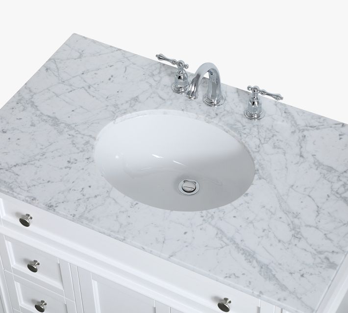 Top view of sink and marble countertop showing faucet mounts