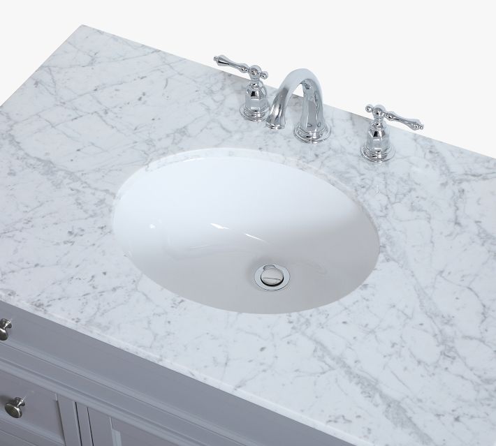 Close-up of marble sink countertop with faucet handles