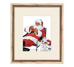 Santa's Milk and Cookies Framed Print by Norman Rockwell
