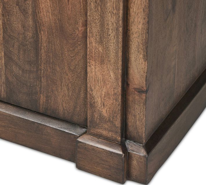 Close-up of base and corner molding on wood cabinet