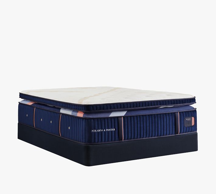 Another perspective of the mattress with removable cover, showing navy base and label.