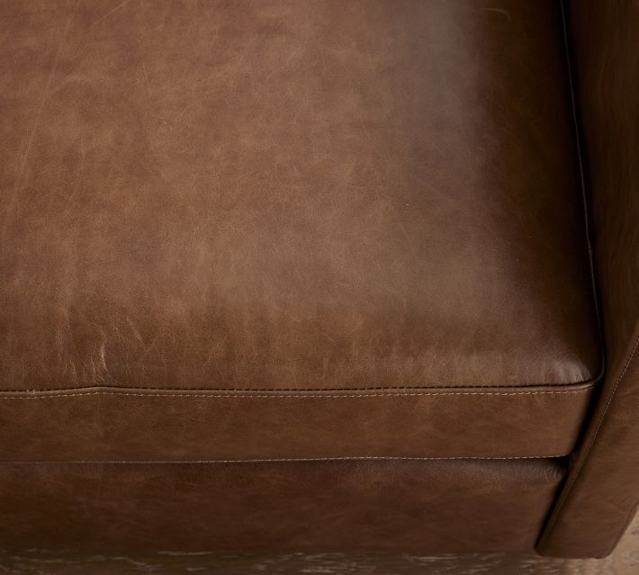 Close-up of brown leather seat cushion with stitching