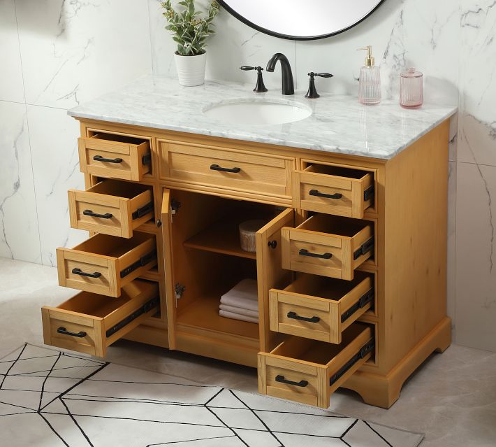 Open drawers of wooden vanity showing storage space and neatly arranged contents