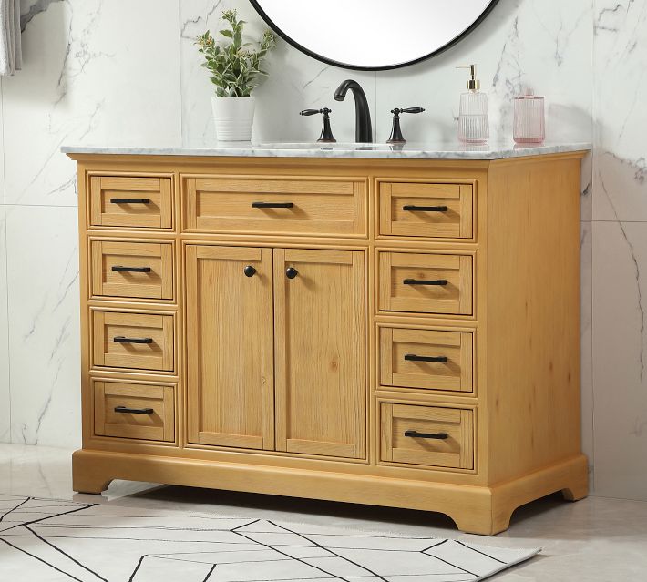Close-up of wooden vanity drawers and curved base, natural wood finish