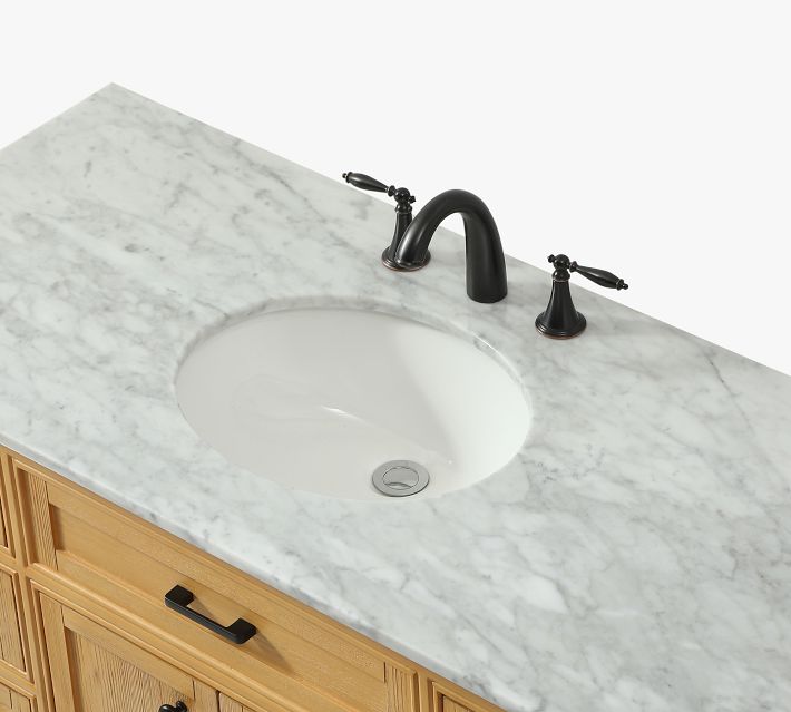 Close-up of marble countertop with built-in sink and black faucet