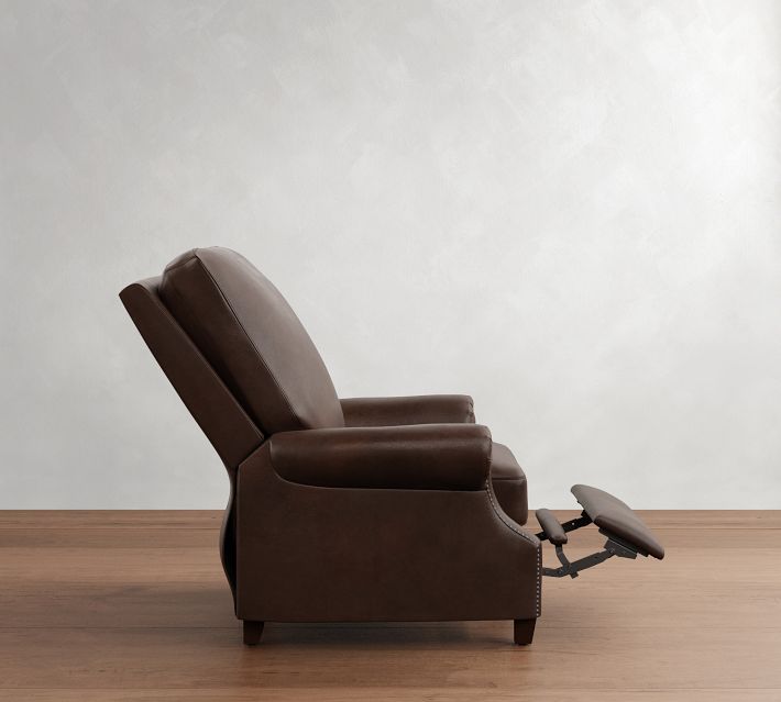 Profile side view of a brown leather recliner with footrest extended mid-recline