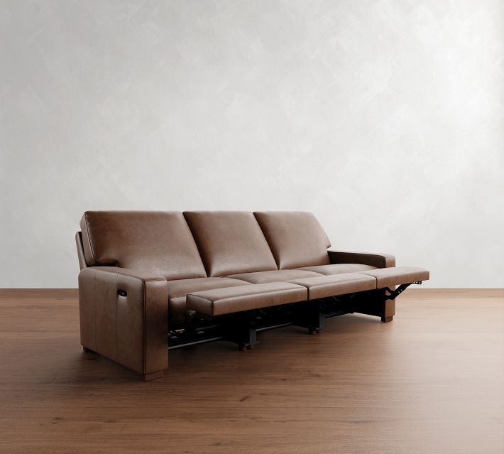 Open chaise/footrest extension of a brown leather sofa