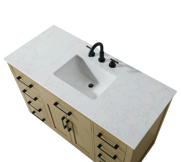Angle shot of light wood countertop vanity with marble sink integrated.