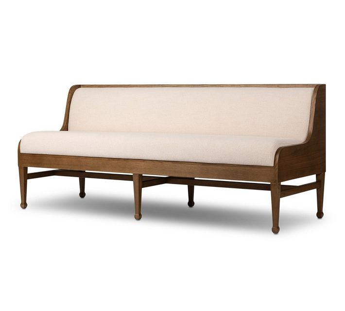 A wooden sofa with light beige upholstery and mid-century style legs.