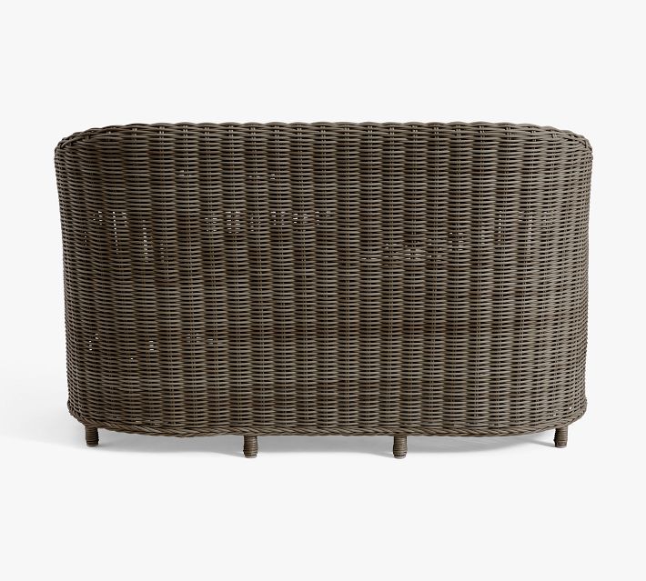 Back of brown wicker sofa with tight weave pattern