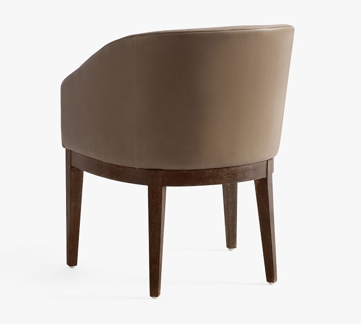 Rear view of brown leather armchair showing curved back and wooden legs