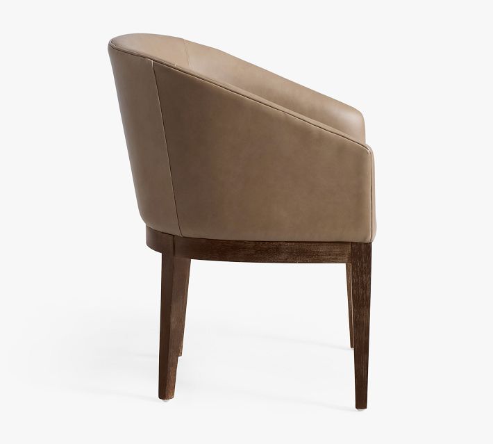 Side view of brown leather armchair showing curved back and wooden legs
