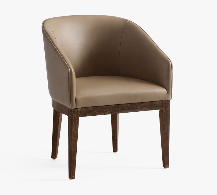 Armchair with curved back and brown leather upholstery on wooden legs