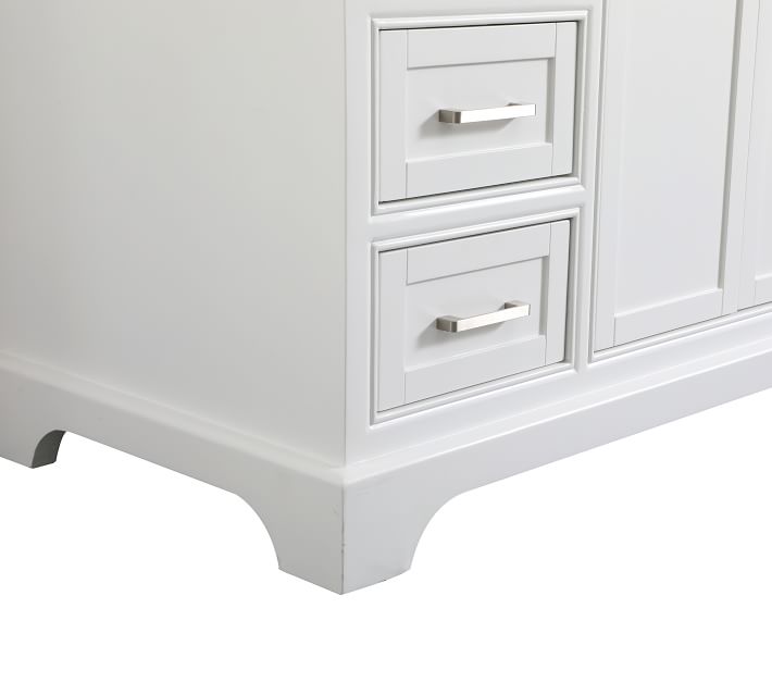 Base of white vanity showing curved feet and plinth