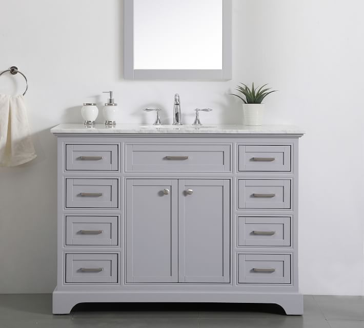 Front view of light gray vanity with marble top and faucet