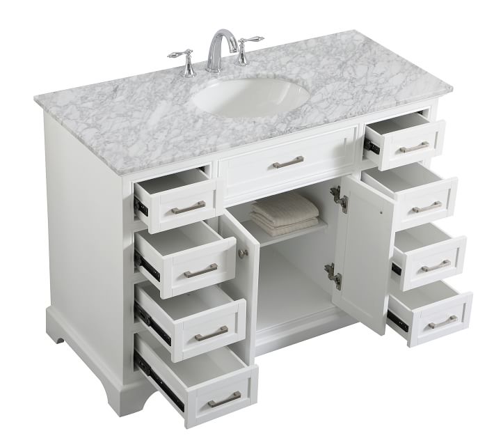 Vanity with open cabinet space and multiple drawers, marble countertop, two side columns