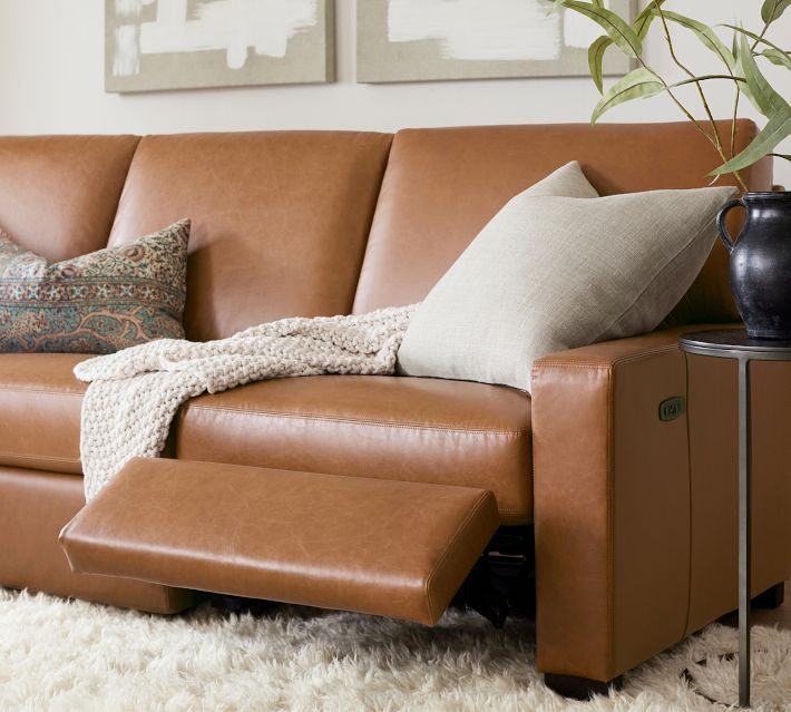 Close-up of power/USB port on recliner arm of leather sofa